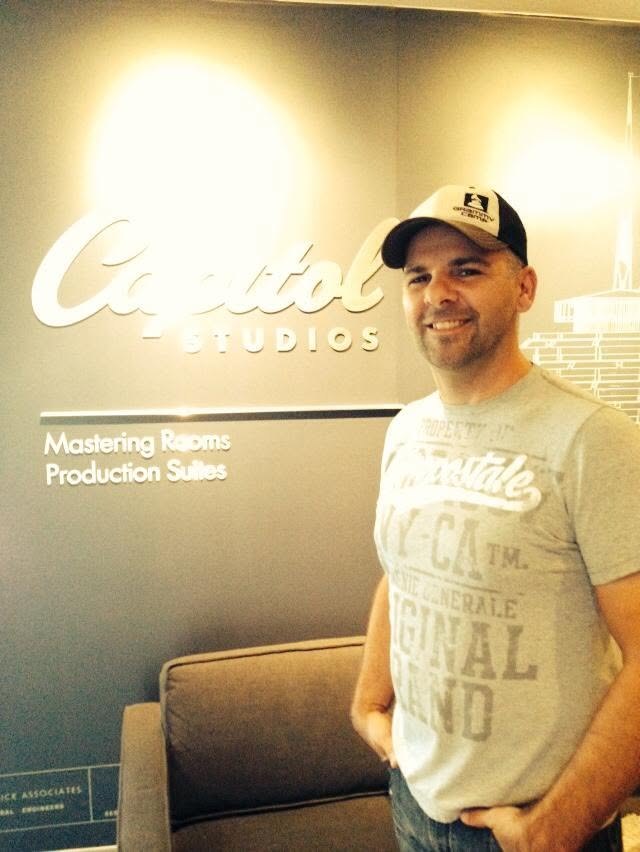 Nathan Adam at the Capitol Studios mastering rooms sign in Los Angeles