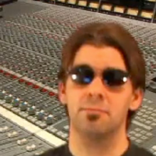 A younger Nathan Adam at a large analog mixing console