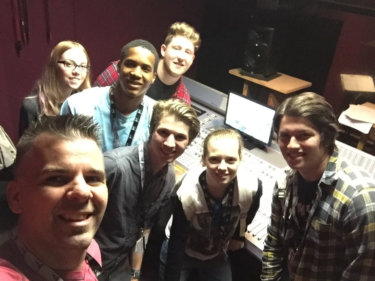 A room of students working at iMacs with headphones and MIDI keyboards during a GRAMMY Camp Weekends session