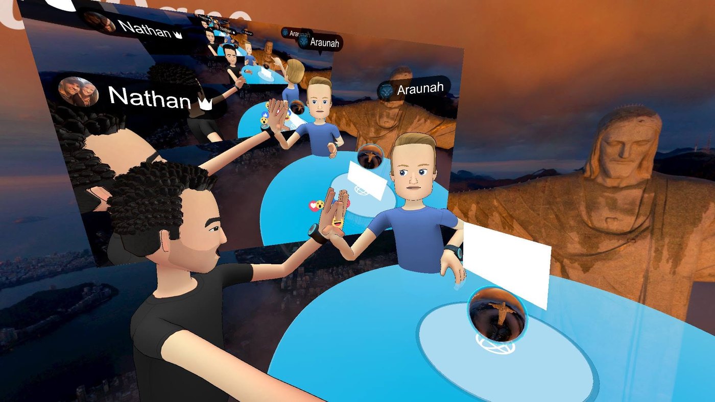 A virtual reality social space showing photo panels, a table and avatars including one of Nathan Adam