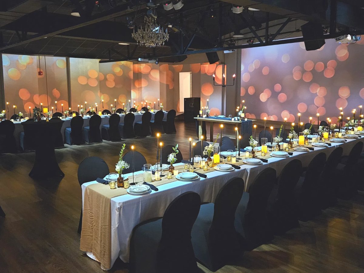 The Walnut House arranged for a formal dinner with candlelit tables and bokeh projections
