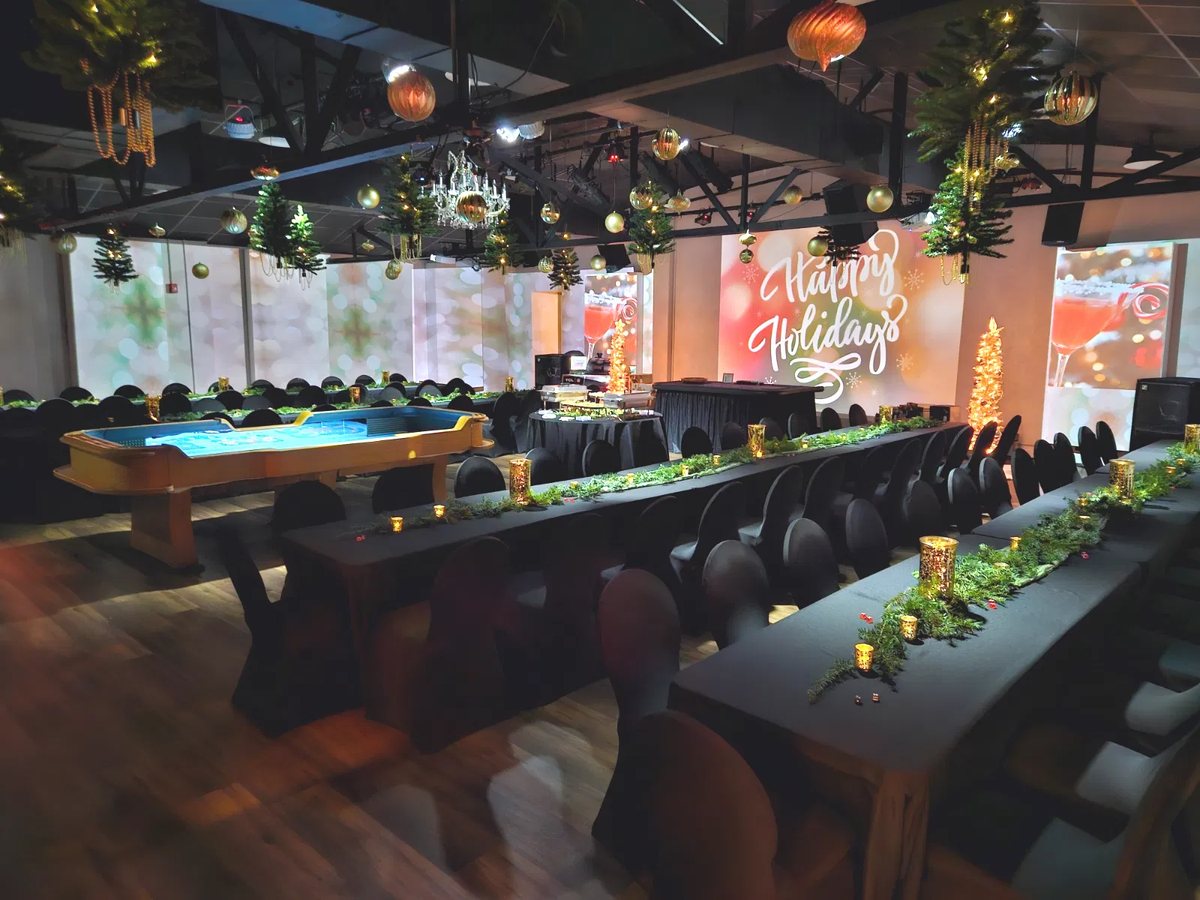 The Walnut House set for a holiday dinner, long tables and projection-mapped walls